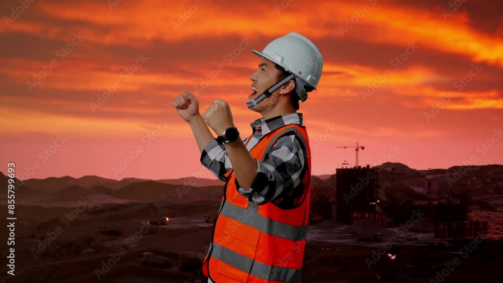 Side View Of Asian Male Engineer With Safety Helmet Screaming Goal Celebrating Working at Construction Site, Mining Machinery Side View Of Asian Male Engineer With Safety Helmet Screaming Goal Celebrating Working at Construction Site, Mining Machinery