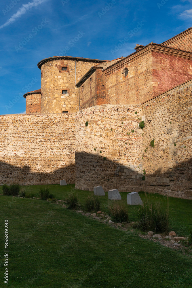 Roman stone walls of the city of Leon and the old prison in the background in a sunny day. Spain. Roman stone walls of the city of Leon and the old prison in the background in a sunny day. Spain.