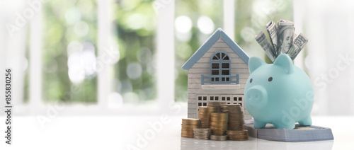 Mortgage concept by money house from model house on coins ,business home idea