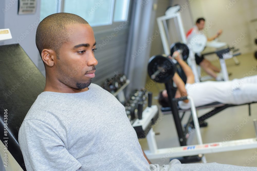man focused on working out in gym man focused on working out in gym