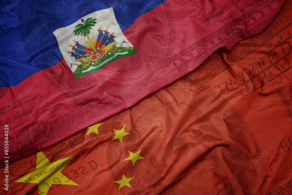 waving colorful flag of haiti and national flag of china on the dollar money background. finance concept. waving colorful flag of haiti and national flag of china on the dollar money background. finance concept.