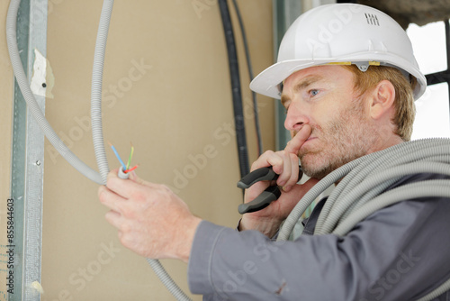 electrician technician looking at electric cable