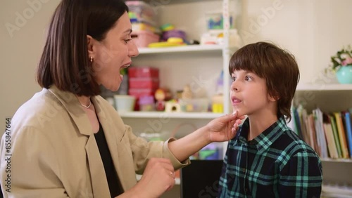 Cute preschool child is engaged in speech therapist office and correcting his speech