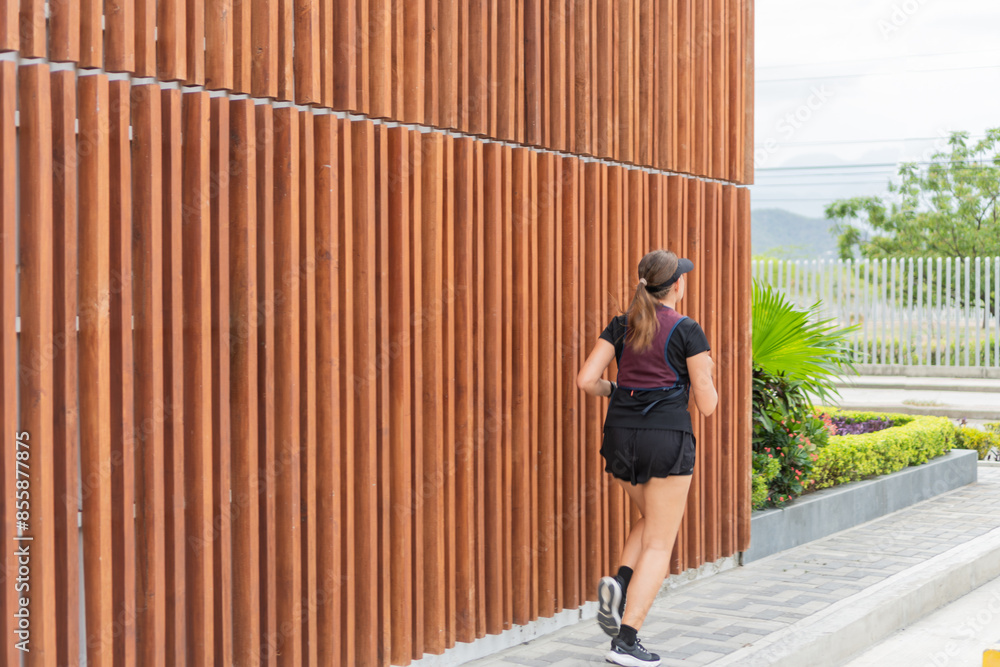 Woman Running Along Wooden Fence Woman Running Along Wooden Fence