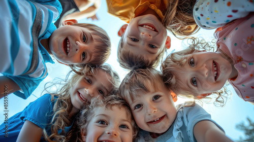 Group of happy children forming a circle smiling together