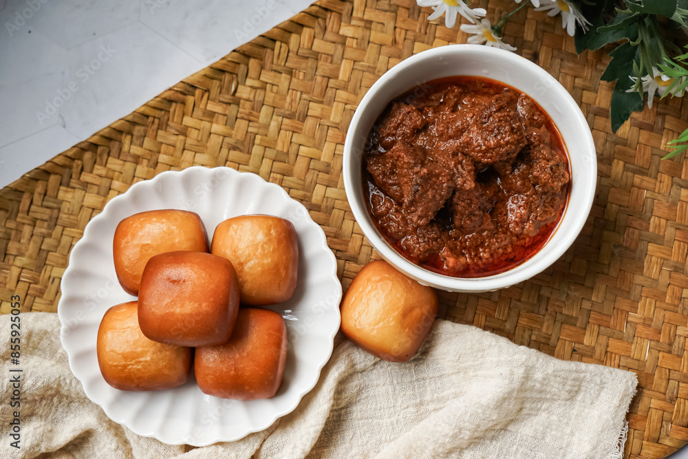 Fried Mantou served in white plate with Beef Rendang. Fusion food. Fried Mantou served in white plate with Beef Rendang. Fusion food.