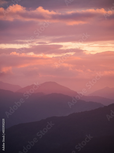 Beautiful misty mountain forest in sunset time