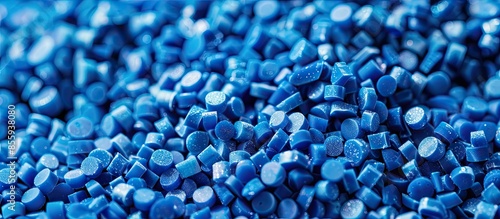Close-up of blue plastic polymer granules. polymer plastic. compound polymer. PVC resin compounds. Tinted plastic granulate for injection moulding process. Copy space image