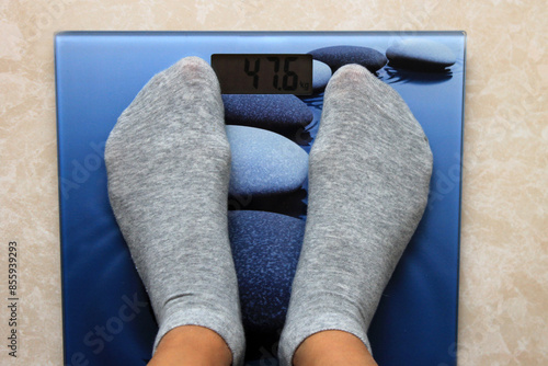 girl stepped on the scales, low body weight