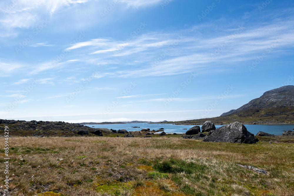 Greenland Nanortalik arctic lava stones volcanic mountain landscape on a sunny day with feather clouds Greenland Nanortalik arctic lava stones volcanic mountain landscape on a sunny day with feather clouds