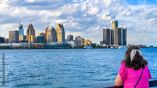 Female tourist looking at the Detroit cityscape, Windsor, Canada photo