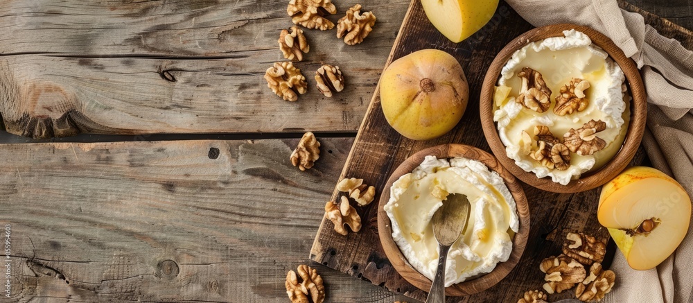 Appetizers of fresh goat cheese and quince paste with walnuts on a wooden background. Healthy cooking. Copy space image. Place for adding text and design Appetizers of fresh goat cheese and quince paste with walnuts on a wooden background. Healthy cooking. Copy space image. Place for adding text and design