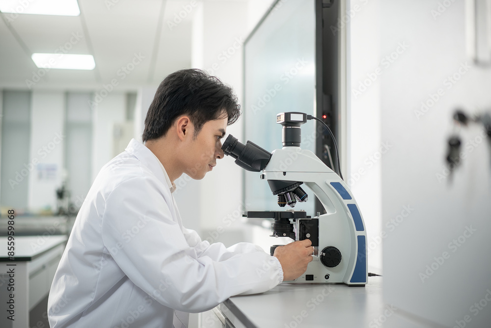 doctor using microscope in lab doctor using microscope in lab