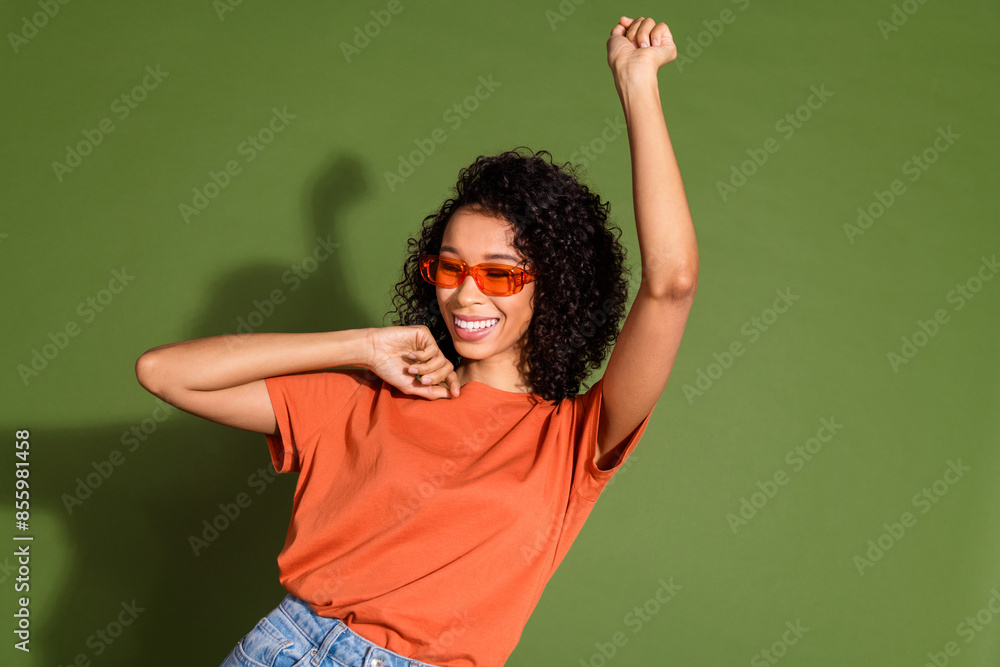 Photo portrait of lovely young lady sunglass dancing dressed stylish orange garment isolated on khaki color background Photo portrait of lovely young lady sunglass dancing dressed stylish orange garment isolated on khaki color background