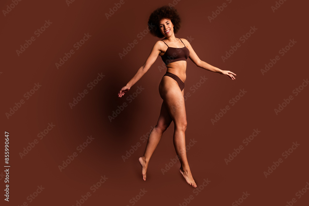 Full length photo of funny adorable lady underwear jumping accepting imperfect skin isolated brown color background Full length photo of funny adorable lady underwear jumping accepting imperfect skin isolated brown color background