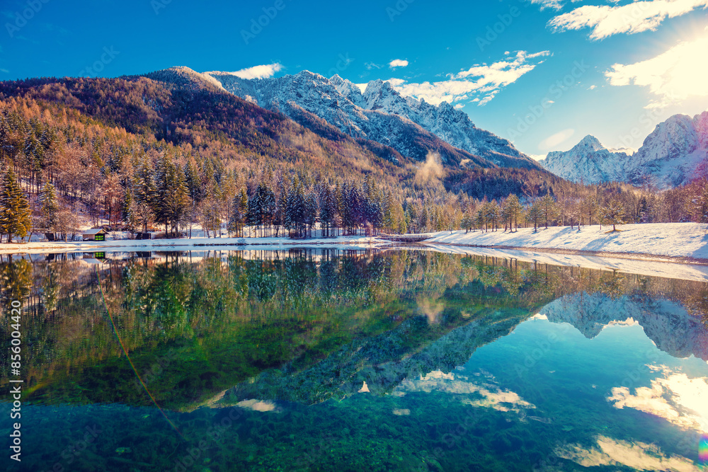 Obraz premium Mountain valley with the river in winter. The tops of the mountains are covered with snow. View of the Alps in Kranjska Gora at sunrise. Triglav national park. Slovenia, Europe