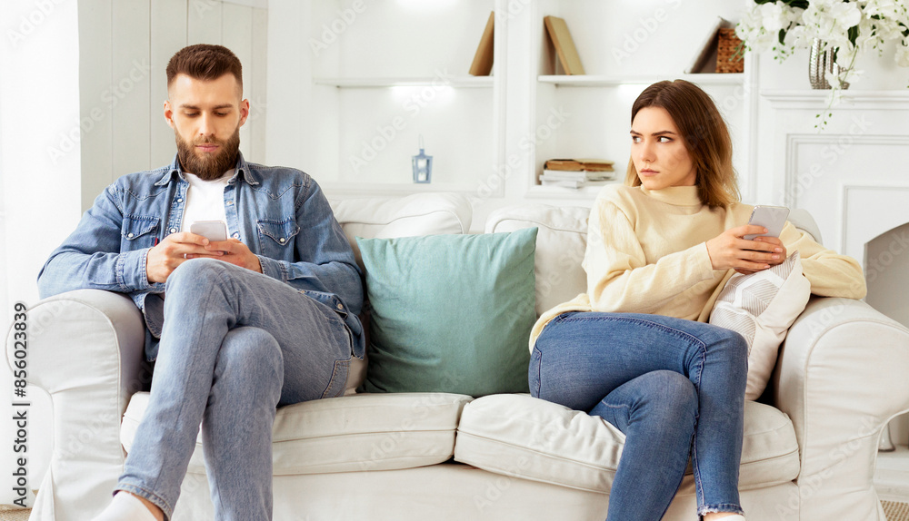 Couple Crisis. Man Using Phone, Not Paying Attention To Wife, Sitting On Couch Couple Crisis. Man Using Phone, Not Paying Attention To Wife, Sitting On Couch