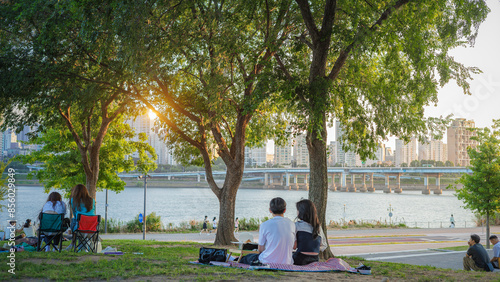 People enjoying a picnic at Hangang Park at sunset
