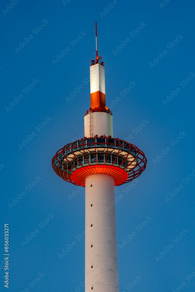 A striking view of a modern observation tower with a red and white color scheme, extending into a clear blue sky, highlighting its intricate design and structural details. A striking view of a modern observation tower with a red and white color scheme, extending into a clear blue sky, highlighting its intricate design and structural details.
