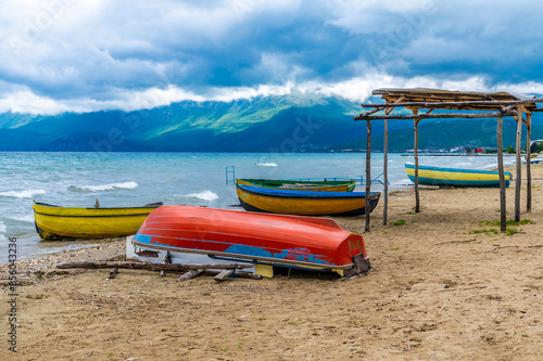 A view of boats pulled up on the shores of Lake Ohrid in Podgradec, Albania in summertime photo