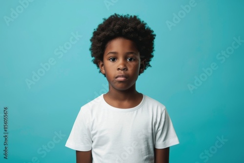 Portrait of a little cute boy on turquoise background