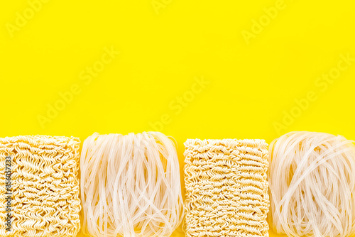 Geometric design with Chinese, Japanese products, noodles, rice vermicelli on yellow background top view mock up photo