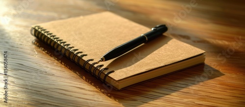 A notebook with a pen sitti...