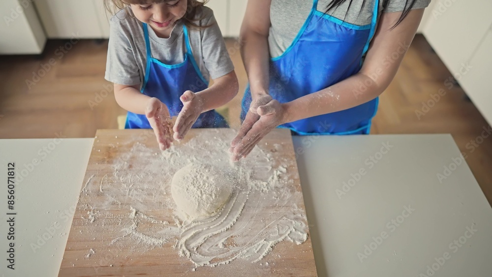© maxximmm - mother daughter preparing dough in the kitchen. happy family cooking baking together. mother and small child bake preparing homemade cakes from flour and dough. happy family cooking at home © maxximmm - mother daughter preparing dough in the kitchen. happy family cooking baking together. mother and small child bake preparing homemade cakes from flour and dough. happy family cooking at home