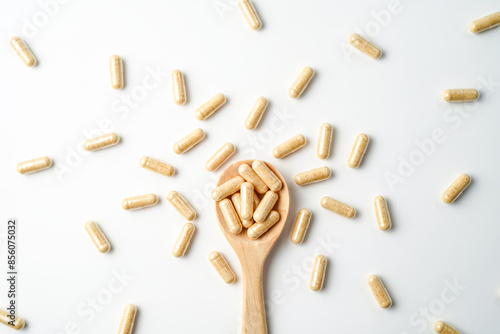 Herbal capsules in wooden spoon, Natural herbs, Alternative Medicine, Herbal supplement