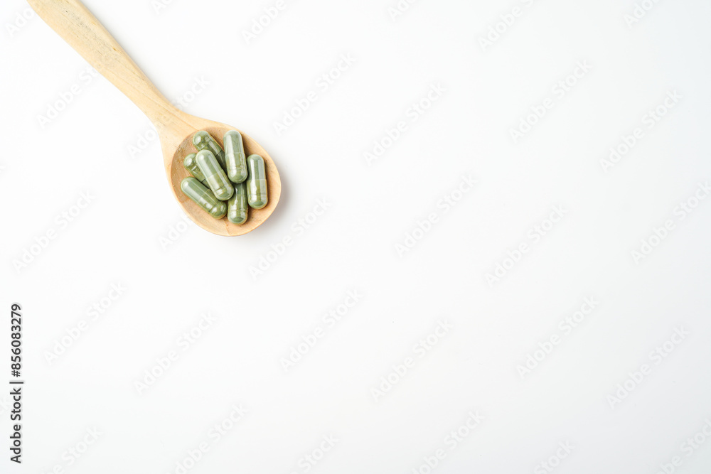 Herbal capsules in wooden spoon, Natural herbs, Alternative Medicine, Herbal supplement Herbal capsules in wooden spoon, Natural herbs, Alternative Medicine, Herbal supplement