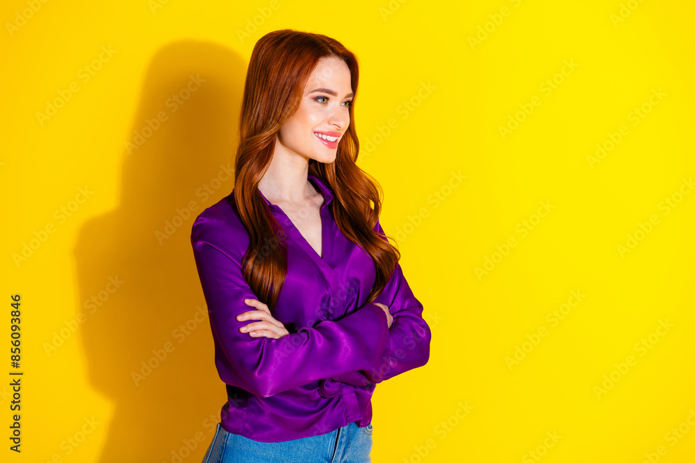 Photo portrait of attractive young woman look empty space crossed hands dressed stylish violet clothes isolated on yellow color background Photo portrait of attractive young woman look empty space crossed hands dressed stylish violet clothes isolated on yellow color background