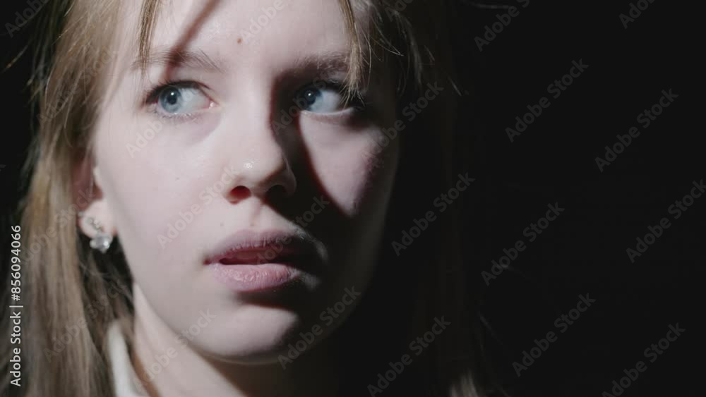 The young woman shows emotions of fear on her face The young woman shows emotions of fear on her face