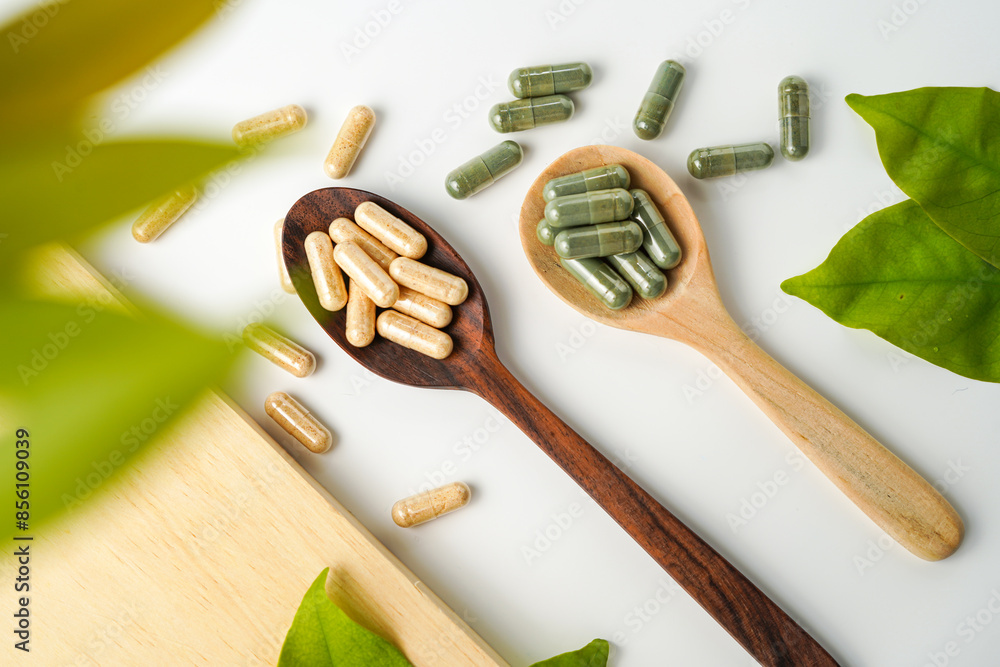 Herbal capsules in wooden spoon, Natural herbs, Alternative Medicine, Herbal supplement Herbal capsules in wooden spoon, Natural herbs, Alternative Medicine, Herbal supplement