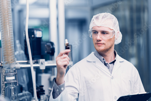 Scientist in Science Lab proudly invented New Medicine Formula. Medical factory staff happy smiling with Concentrate Medical Extract from Plant.