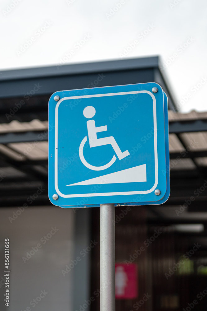 Wheelchair icon symbol signpost at car parking place, reserved for disability person. Transportation symbol object, close-up. Wheelchair icon symbol signpost at car parking place, reserved for disability person. Transportation symbol object, close-up.