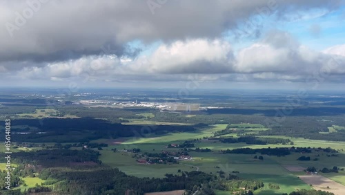 Descent and approach and landing from cockpit of airplane, plane aircraft in Stockholm Arlanda airport in summer with green grass fields and forest photo