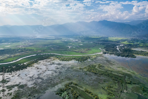 A picturesque scene with a lake, mountains from drone, and a town seen in the distance, lake Wular, Kashmir, India photo