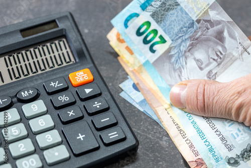 Obraz na płótnie Brazilian Reais banknotes, Calculator and money file, financial settlements, household budget, taxes, Brazil currency exchange rate, financial analysis, economic and business concept w salonie