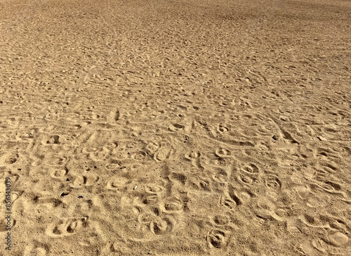 An empty dirt horse corral ground lies silent, its dusty surface showing hoof prints, evoking a rustic and tranquil atmosphere, waiting for the next spirited activity.