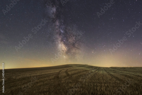 Milky Way over a hill of recently harvested cereal in the Vega-Valdavia region, Palencia photo