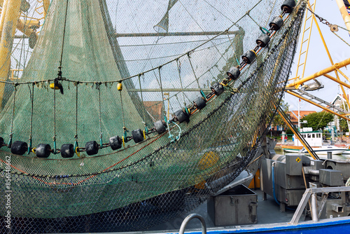 Traditional old german fishing cutter boats moored Neuharlingersiel harbor Wadden sea East Frisia Northern Germany. Commercial fish crab shrimp trawler beam trawl nets North Sea small port city