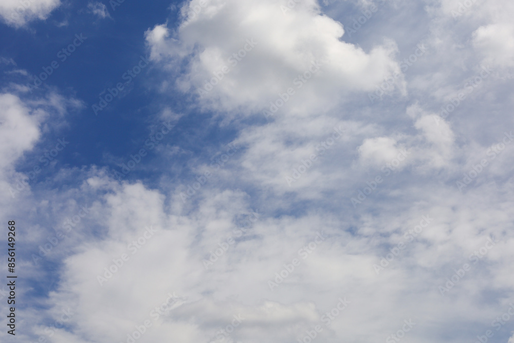 Panoramic photo of a blue sky with white cumulus clouds. Design of backgrounds, screensavers, postcards, covers. Panoramic photo of a blue sky with white cumulus clouds. Design of backgrounds, screensavers, postcards, covers.