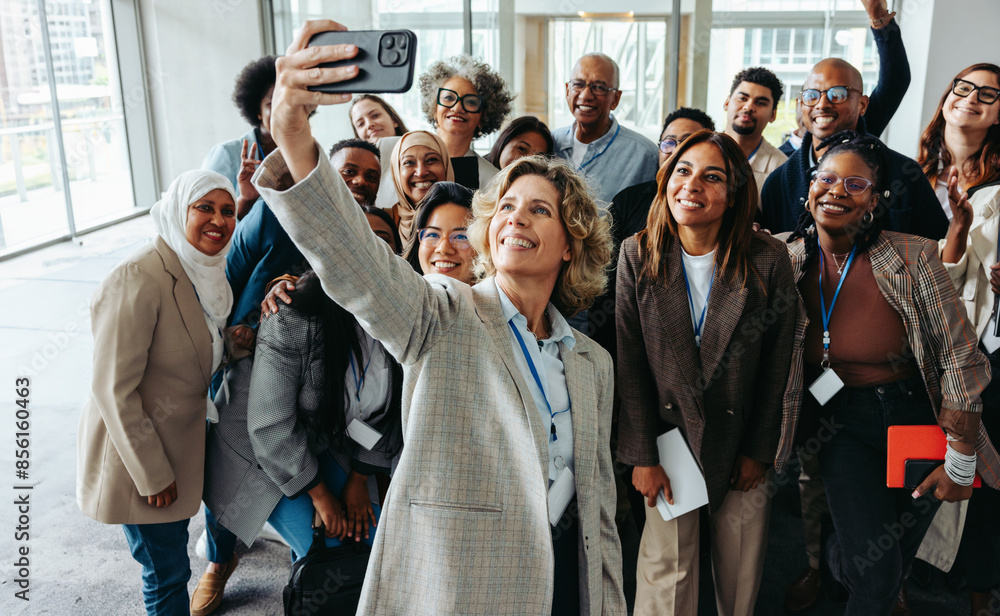 © Jacob Lund - Diverse team taking a group selfie during seminar or workshop