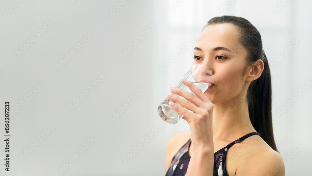Healthy Lifestyle. Young Woman Drinking Fresh Water After Training At Home Healthy Lifestyle. Young Woman Drinking Fresh Water After Training At Home