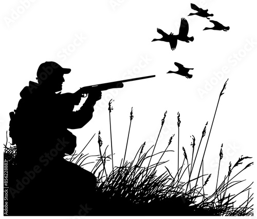 Silhouette of a hunter hunting ducks with a shotgun