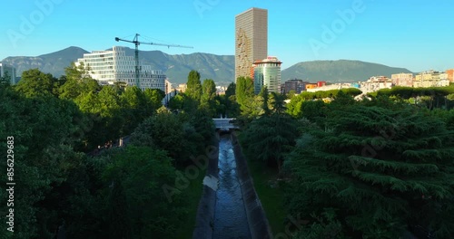 Aerial view of Tirana cityscape over Lana canal showing the mount Dajt on the Horizon.  photo