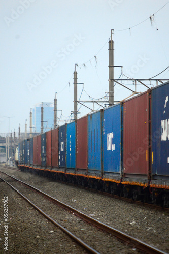 View of a container train traveling in a rural area