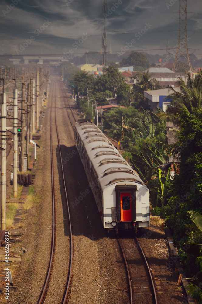 Obraz premium View of a passenger train traveling in a rural area
