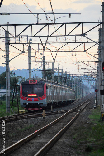 View of a passenger train moving in a rural or hilly area