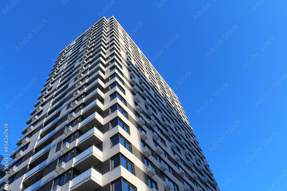 new modern building on background of blue sky, beautiful new apartment building new modern building on background of blue sky, beautiful new apartment building